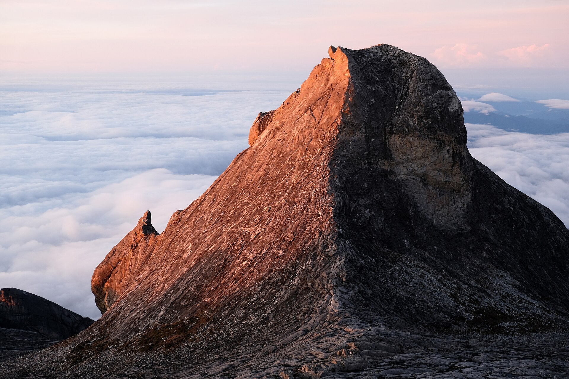The majestic Mount Kinabalu emerges at dawn, offering breathtaking views.