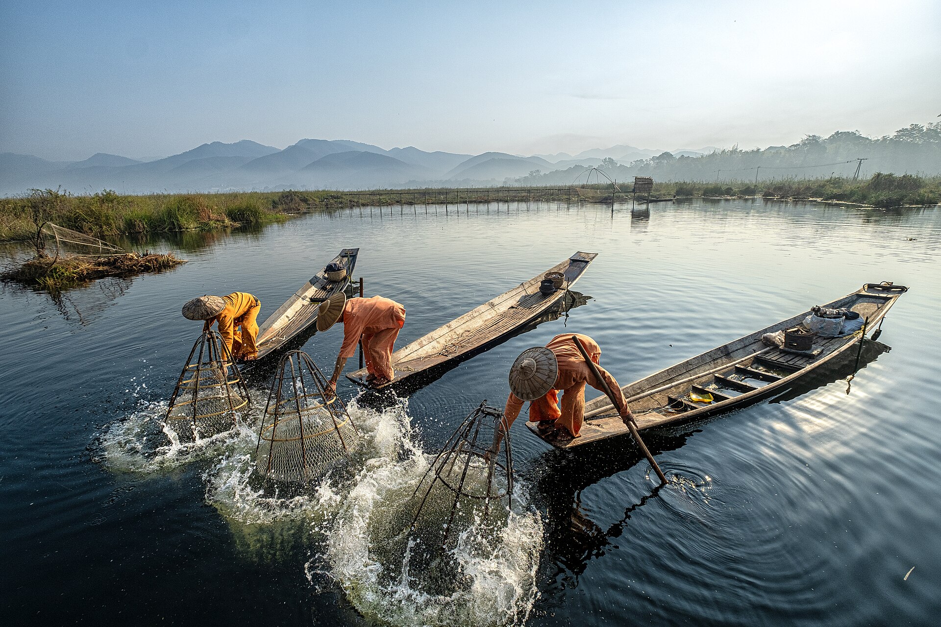The tranquil waters of Inle Lake at sunrise, showcasing the beauty of this unique ecosystem.