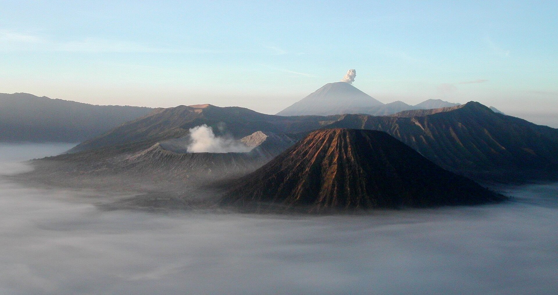 The breathtaking sunrise at Mount Bromo, illuminating the caldera and surrounding peaks.