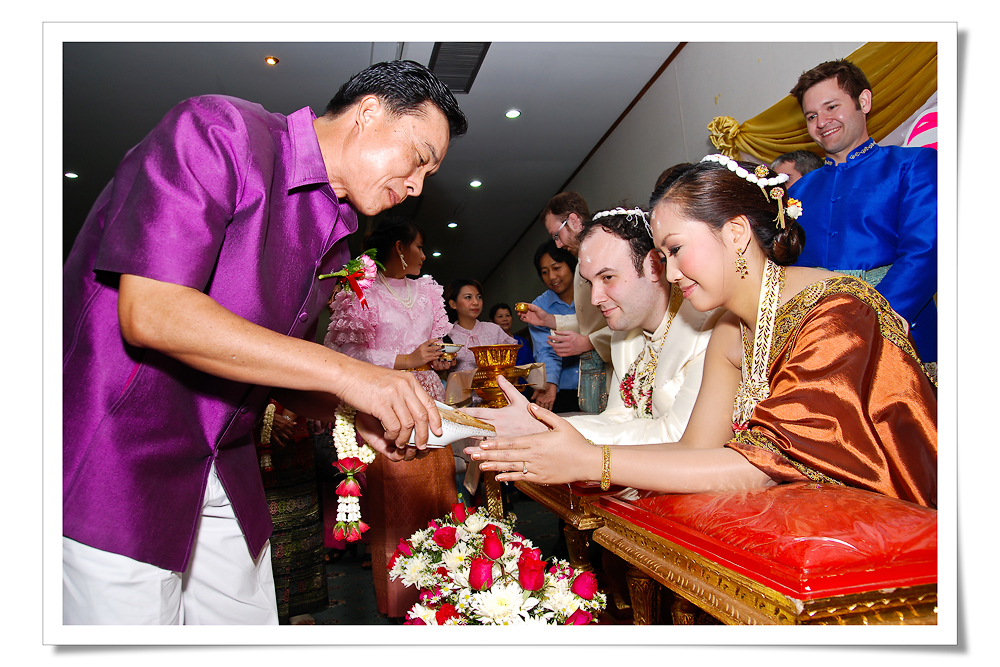 A traditional water pouring ceremony, honoring elders and ancestors during Songkran.